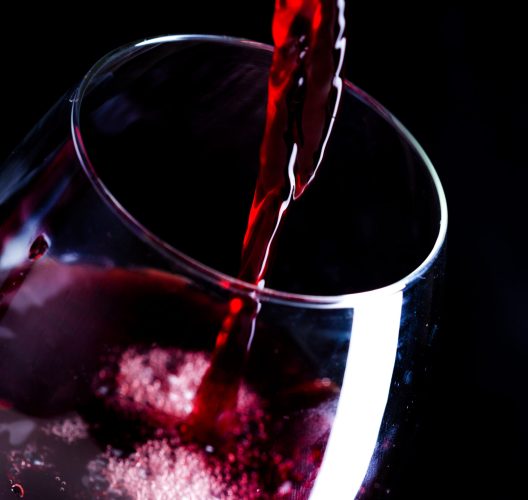 Pouring red wine into the glass